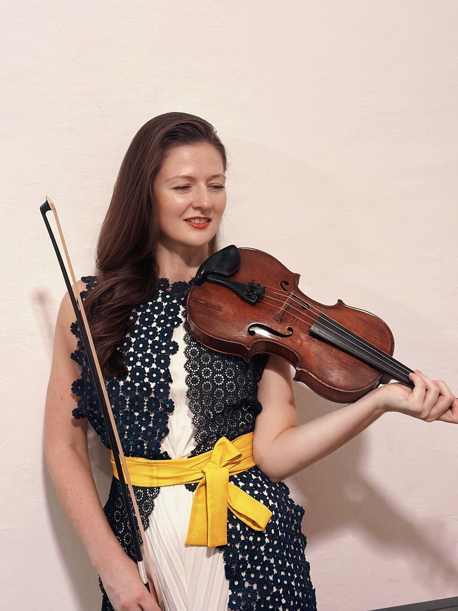 Esther Wilson holding a violin and bow